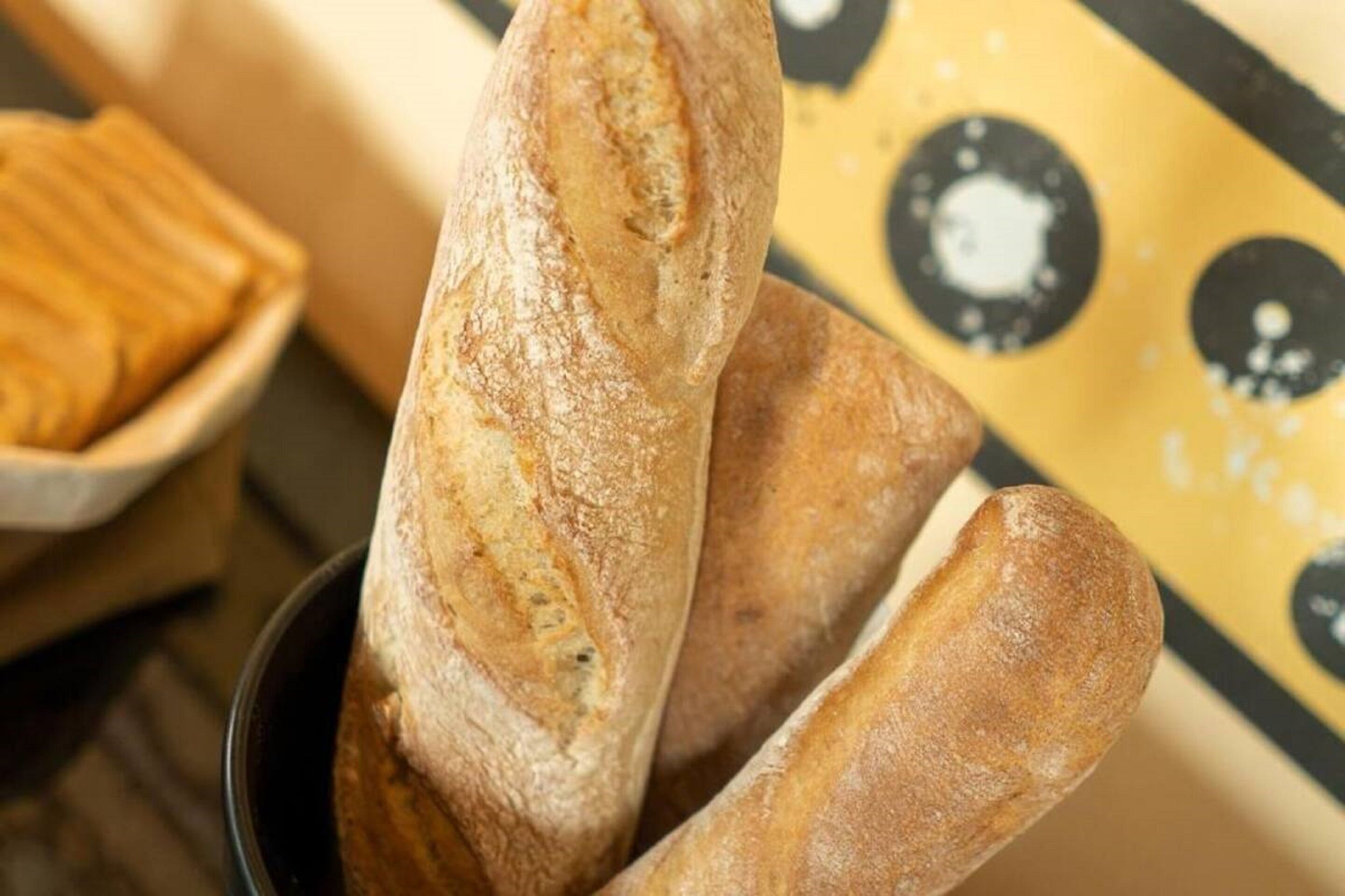 Three baguettes in a black bowl.