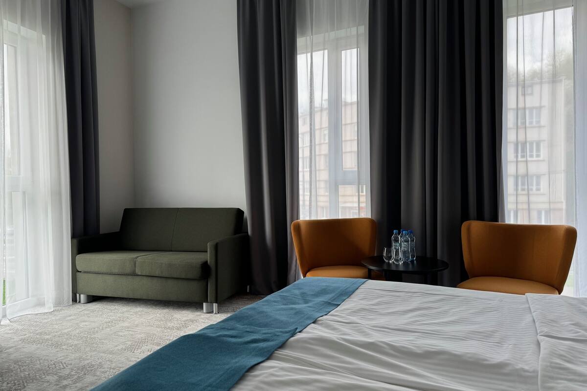 family double room, 1 queen bed | living area | tv