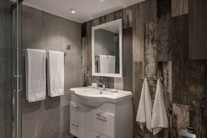 Shower, rainfall showerhead, hair dryer, towels