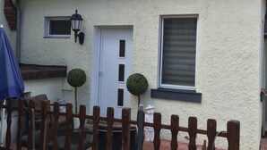 A house with a tiled roof, a white exterior, a small window, and a door. - Hotel Stadt Coblenz (Fachbach)