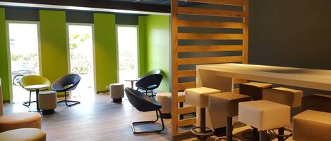 A modern interior with a bar area, seating, and a view of the outdoors.
