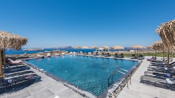 Seasonal outdoor pool, open 9:00 AM to 10:00 PM, pool umbrellas