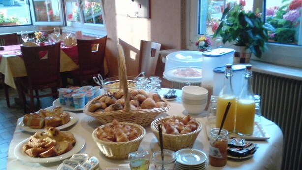 A breakfast buffet with various pastries, bread, and beverages. - Hotel Restaurant De La Poste (Bantzenheim)