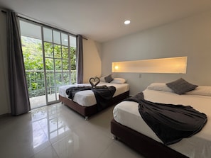 A modern hotel room with two beds, a large window with curtains, a ceiling light, and a wall-mounted light fixture.