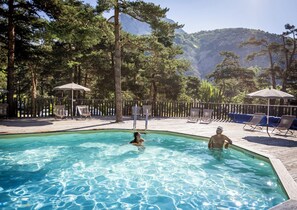 Seasonal outdoor pool, a heated pool, pool umbrellas, pool loungers