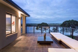 A modern balcony with a view of the landscape.