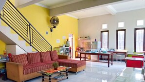 A living room with a sofa, a coffee table, and a staircase.