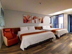 A hotel room with two beds, a massage chair, and a large window.