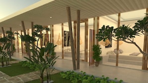 Un bâtiment moderne doté d’un espace extérieur couvert, qui présente un mélange de verdure et d’éléments en bois.