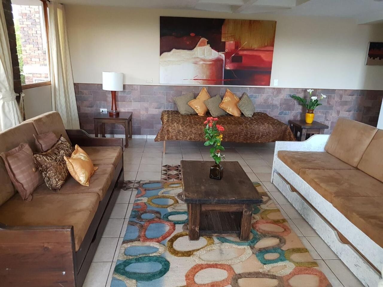 A living room with two sofas, a coffee table, and a rug.