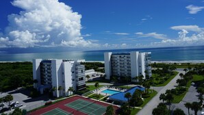 A hotel with multiple buildings, a tennis court, and a pool area. - Hutchinson Island North Beach/Lagoon Access - First Floor Unit (Fort Pierce)