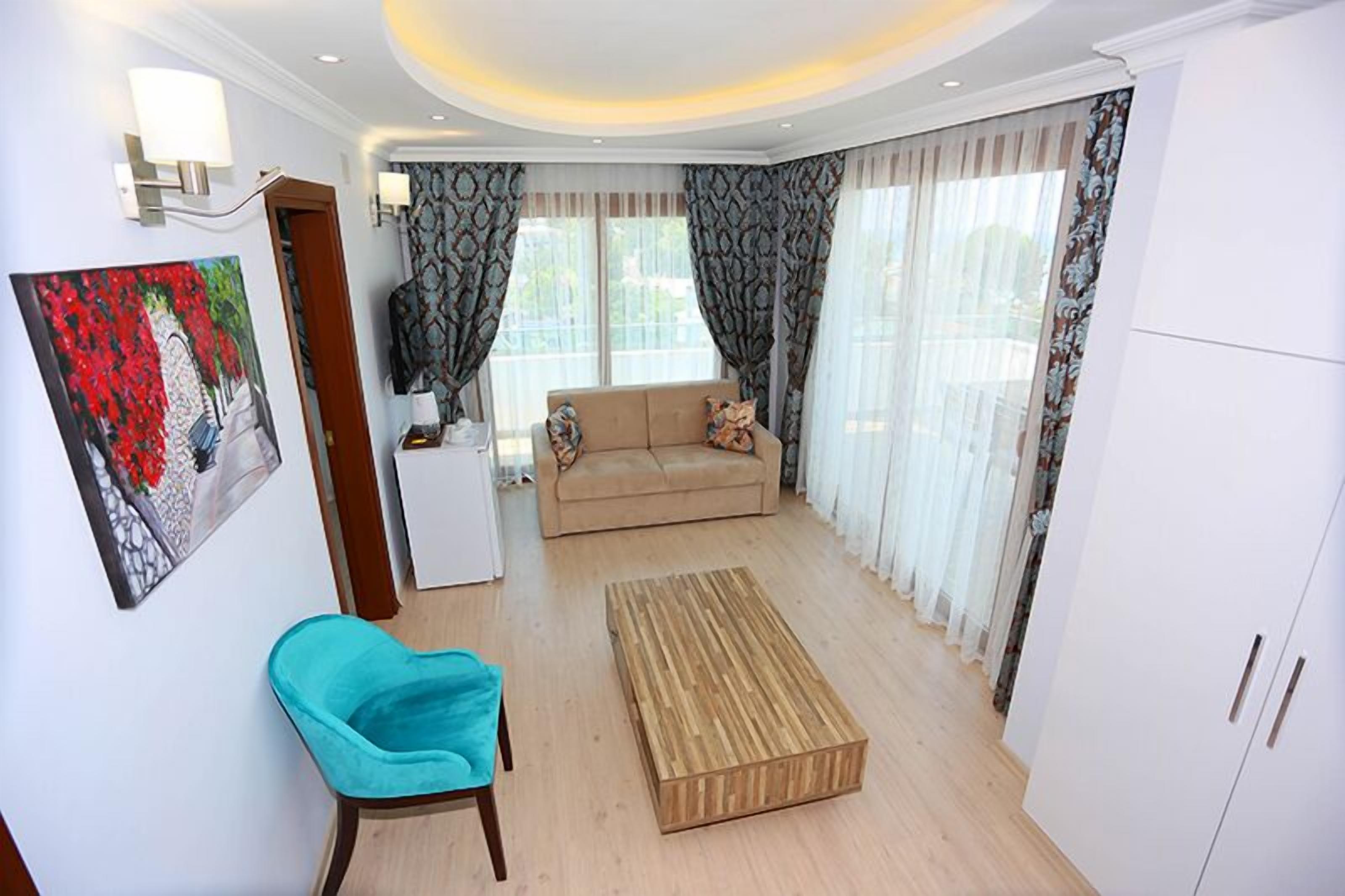 Deluxe Studio Suite, Sea View | Living area | LCD TV