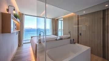 A modern bedroom with a large window, a bathtub, and a wooden wall.