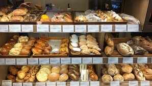 A bakery display case with various baked goods. - North Cottage | Shibuya Studio | Close to Meiji Shrine (Shibuya)