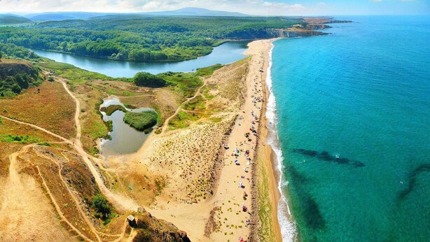 An aerial view of a coastal area with a beach, a river, and surrounding greenery. - Red Hotel - Lozenetz (Tsarevo)