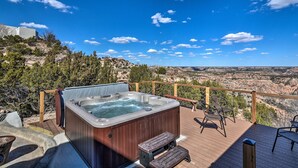 A hot tub on a wooden deck with a scenic view of a canyon. - Charming Texas Home w/ Stunning Canyon Views! (Canyon)