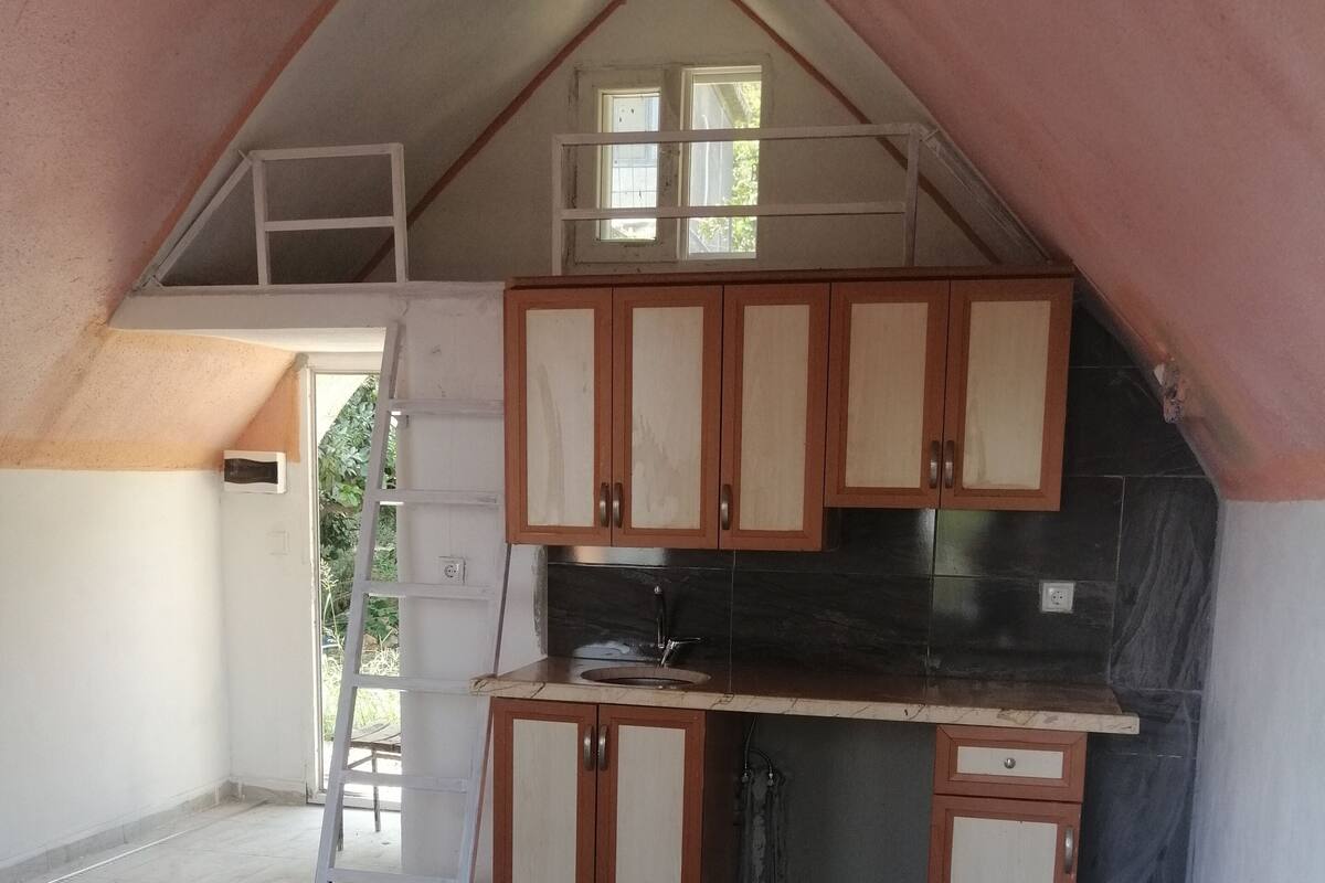 A kitchen with wooden cabinets, a countertop, and a sink.