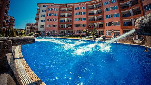 A swimming pool with water features, surrounded by multi-story residential buildings. - MENADA * Privilege Fort Beach * Cosy studio  (Elenite)