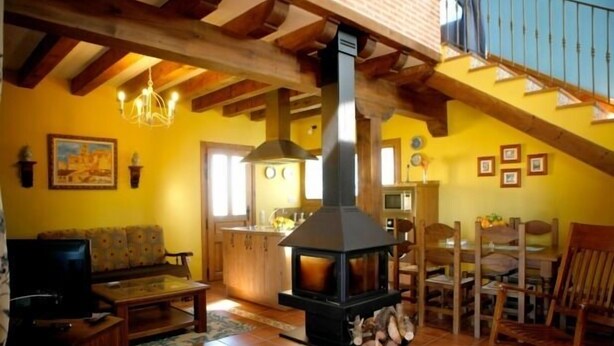 A cozy living room with a fireplace, wooden beams, and a yellow wall. - RURAL HOUSE FOR 2 PEOPLE IN TUREGANO (Turégano)