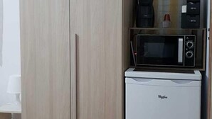 A compact kitchenette with a microwave, coffee maker, and mini-fridge.
