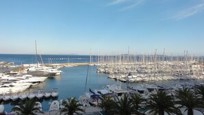A marina with numerous boats docked, a clear sky, and a distant shoreline. - Upscale apartment in a quiet location, accessible for disabled people (Hyères)