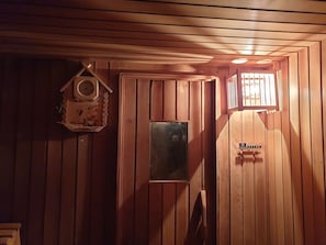 A wooden interior with a clock, a framed picture, and a door with a sign. - HOT A+ Perfect Cosy Retreat Cottage Russki Country Sauna & Spa Cottage Hut (Mount Eliza)