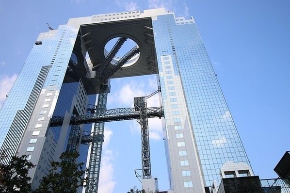 A tall, modern skyscraper with a distinctive circular opening at the top.
