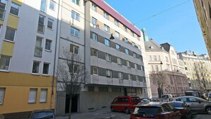 A multi-story building with a flat facade, several windows, and a visible entrance. - Beautiful apartment for 4 guests with WIFI, TV and terrace (Vienna)