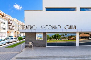 A modern building with the sign 'TEATRO ANTONIO GALA' indicating a theater.