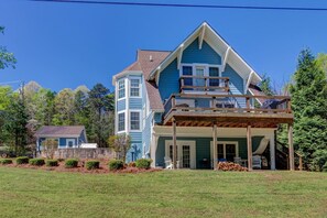 Enjoy a peaceful retreat in this charming two-story home with a spacious balcony and beautifully manicured lawn.