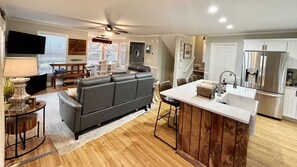 Relax in this inviting space with a comfortable sofa, dining area, and kitchenette.