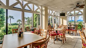 A restaurant with large windows, wooden tables, and chairs. - Beautiful Oceanfront Suite w/ Great View + Official On-Site Rental Privileges (Myrtle Beach)