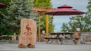 A wooden sign with 'EKTIMO VINEYARDS' and a flamingo logo. - Green Valley, Sonoma County Vacation Rental at a Working Winery. (Sebastopol)