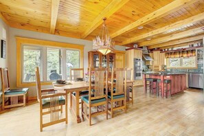 Enjoy meals at the large dining table with six comfortable chairs, surrounded by stunning views of the landscape.