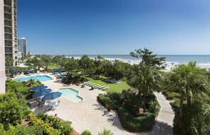 A resort with a swimming pool, beach, and palm trees. - Oceanfront Executive Suite w/ Great View + Official On-Site Rental Privileges (Myrtle Beach)