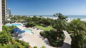 A resort with a swimming pool, beach, and palm trees. - Directly Oceanfront Suite at Family Resort + Official On-Site Rental Privileges (Myrtle Beach)