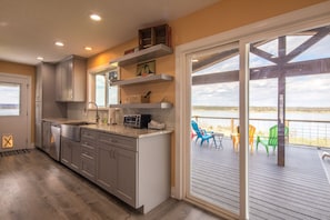 Enjoy a meal in the kitchen with an oven and microwave, then step outside to the adjacent deck with ocean views.