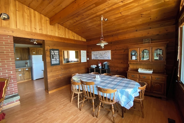 Open concept, bright natural light, spacious dining seating for 10. Extra dishes