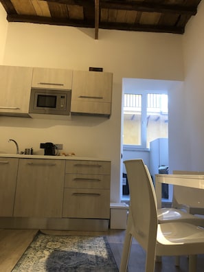 Fridge, microwave, stovetop, coffee/tea maker
