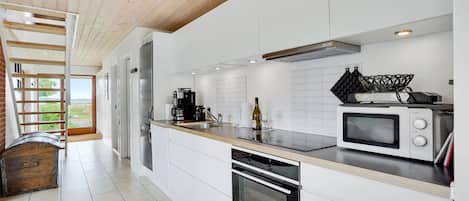 Fridge, stovetop, dishwasher, coffee/tea maker