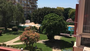 A residential area with a multi-story building, a well-maintained garden, and a clear sky. - Family studio 10 min walk from the beach (Benalmádena)