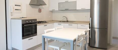 Fridge, oven, dishwasher, dining tables