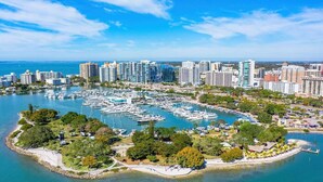 A marina with numerous boats, surrounded by residential buildings and greenery. - 2 BR Condo-Short Walk to Siesta Beach/ One 25 lbs Dog Allowed (Siesta Key)