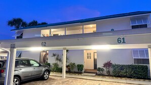 A two-story building with the numbers 62 and 61 on the facade, a covered parking area, and a car parked in front. - 2 BR Condo-Short Walk to Siesta Beach/ One 25 lbs Dog Allowed (Siesta Key)