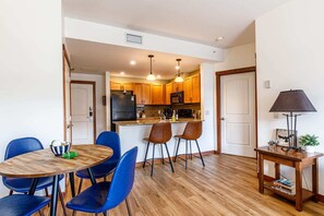 Enjoy meals in this compact kitchen with a dining area featuring a round table and chairs.