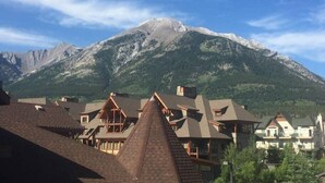 A mountain village with traditional chalet-style buildings and a prominent mountain in the background. - Mountain Paradise"at Falcon Crest Lodge (Canmore)