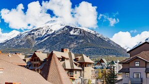 A mountain with snow-capped peaks in the background. - Mountain Paradise"at Falcon Crest Lodge (Canmore)