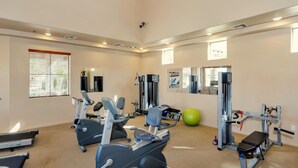 A gym with treadmills, elliptical machines, a bench, and various weight machines. - Resort Style Vacation Condo (Mesa)