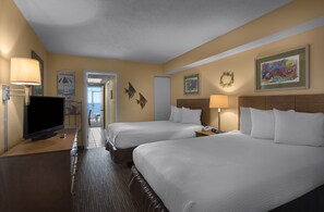 A hotel room with two beds, a TV, a desk, and a view of the hallway. - Directly Oceanfront Suite at Family Resort + Official On-Site Rental Privileges (Myrtle Beach)