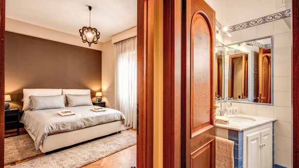 A bedroom with a bed, bedside tables, and a nightstand. - Beautiful apartment near San Pietro. Comfortable, silent, WI-FI, accessories. (Roma)